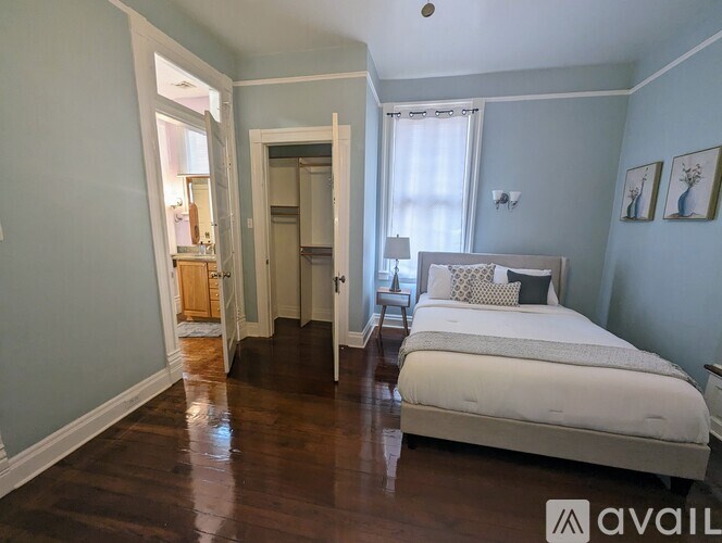 A bedroom with a bed, nightstand, and lamp.