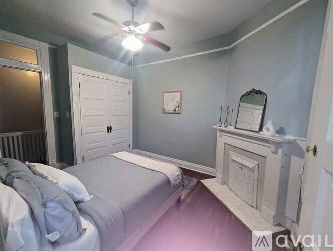A bedroom with a bed, dresser, and mirror.