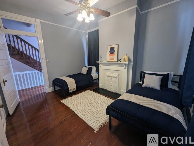 A bedroom with two beds and a dresser.