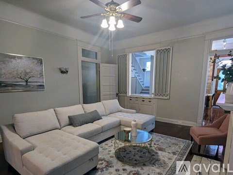 A living room with a white couch and a coffee table.