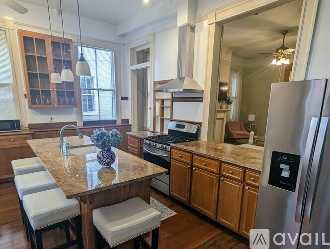 A kitchen with a granite countertop and stainless steel appliances.