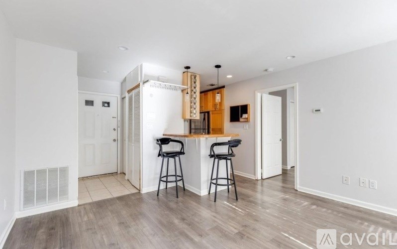 A kitchen with a bar stool and a counter.