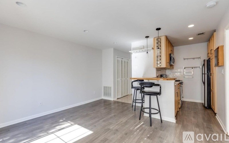 A kitchen area with a bar stool and a countertop.