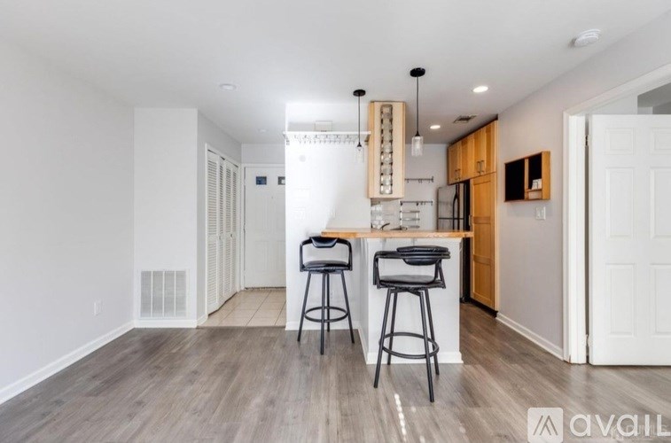 A kitchen area with a bar stool and a countertop.