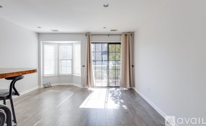 A room with a wooden table and chairs is available for rent.