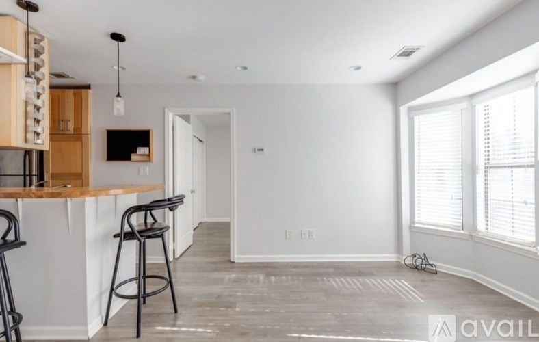 A kitchen with a bar stool and a countertop.