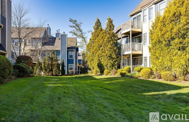 A well-maintained lawn in front of a residential building.