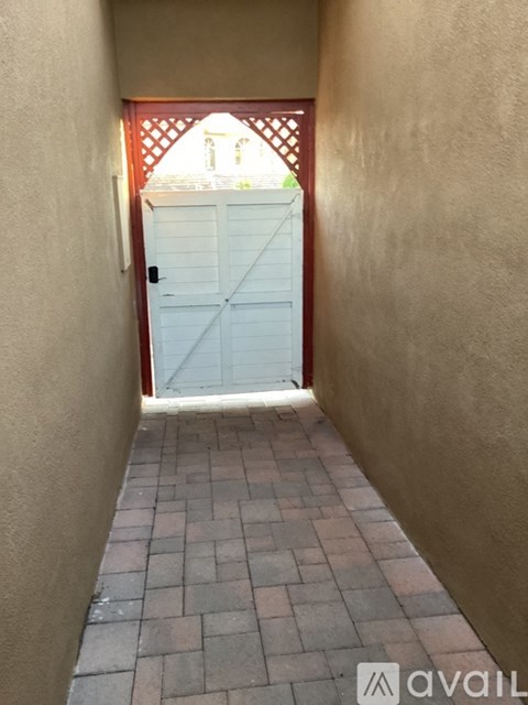 A white door is open to a hallway.
