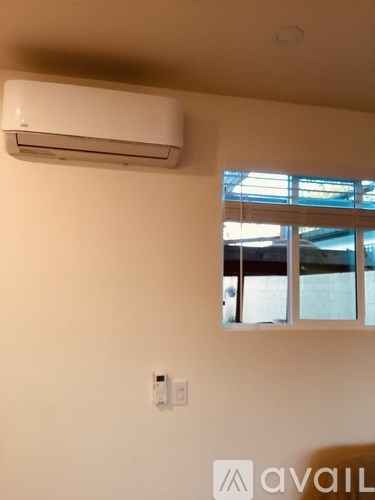 A wall-mounted air conditioner is installed on a wall.