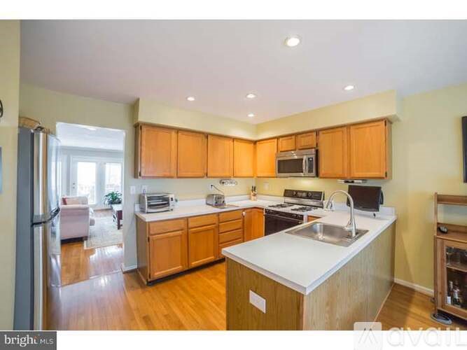 A kitchen with wooden cabinets and a white countertop.