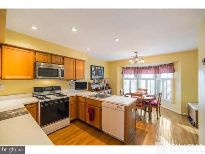 A kitchen with wooden cabinets and stainless steel appliances.