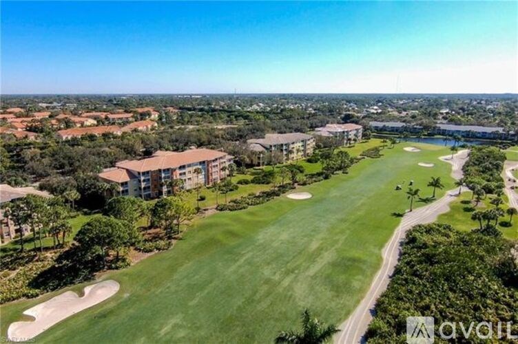 A golf course with a clubhouse in the background.