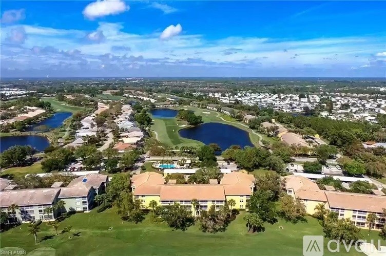 A bird's eye view of a golf course surrounded by buildings.