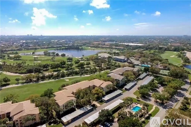A bird's eye view of a residential area with houses, roads, and a body of water.