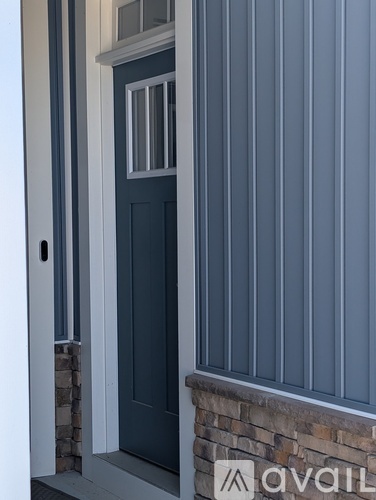 A door with a glass window and a handle.