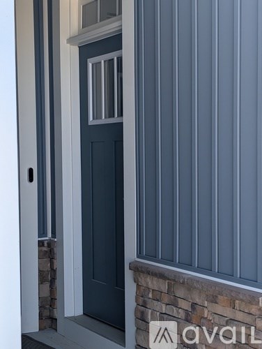 A door with a glass window and a handle.