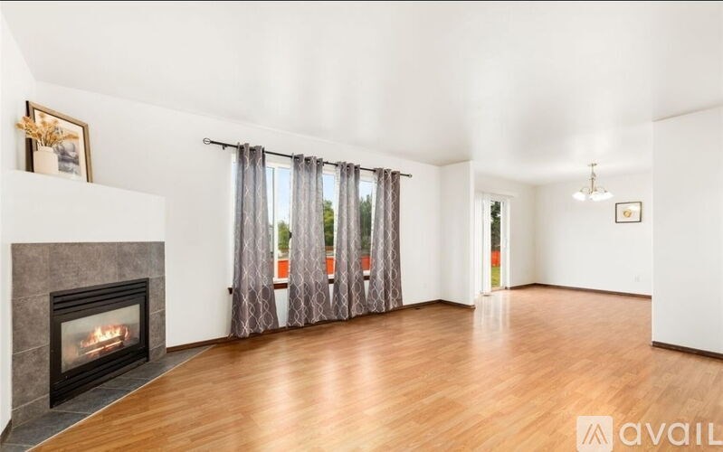 A living room with a fireplace and a view of the outdoors.