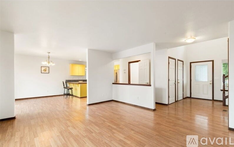 A room with wooden floors and white walls.