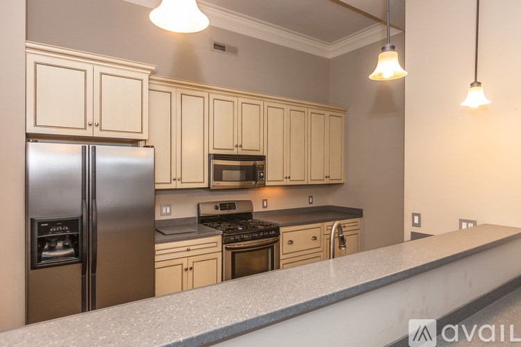 A kitchen with a refrigerator, microwave, oven, and stove.