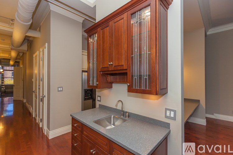 A kitchen with wooden cabinets and a sink.