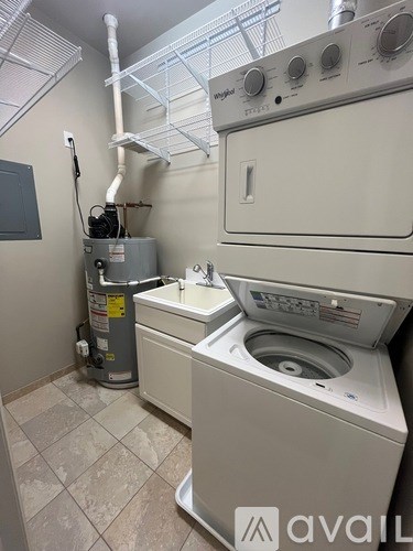 A white dryer and washer are in a small room.