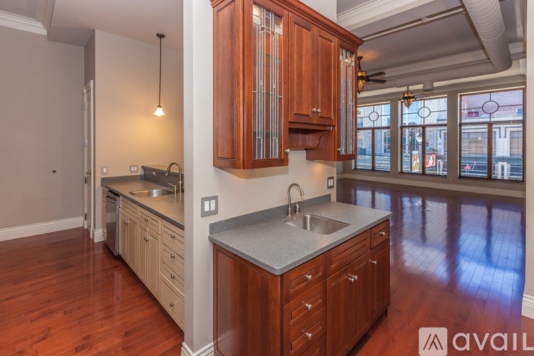 A kitchen with wooden cabinets and a large island.