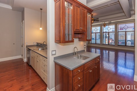 A kitchen with wooden cabinets and a large island.