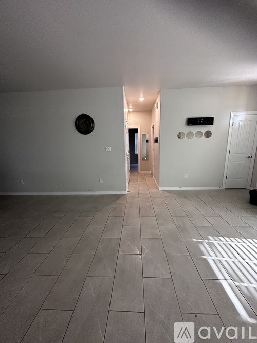 A room with a tiled floor and a white door.
