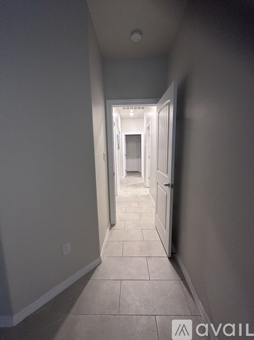 A long hallway with a door at the end.