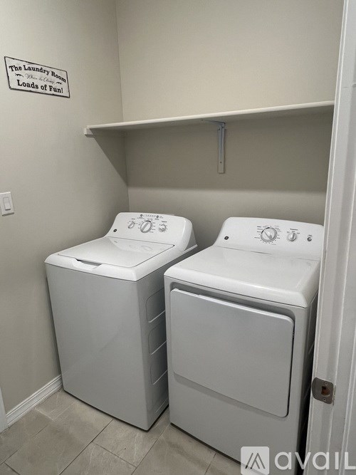 Two front loading washing machines in a laundry room.