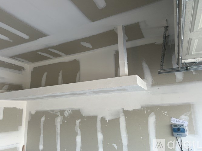 A room with a ceiling that is being painted white.