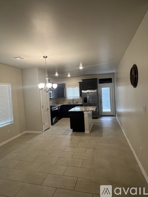 A kitchen area with a dining table and chairs.
