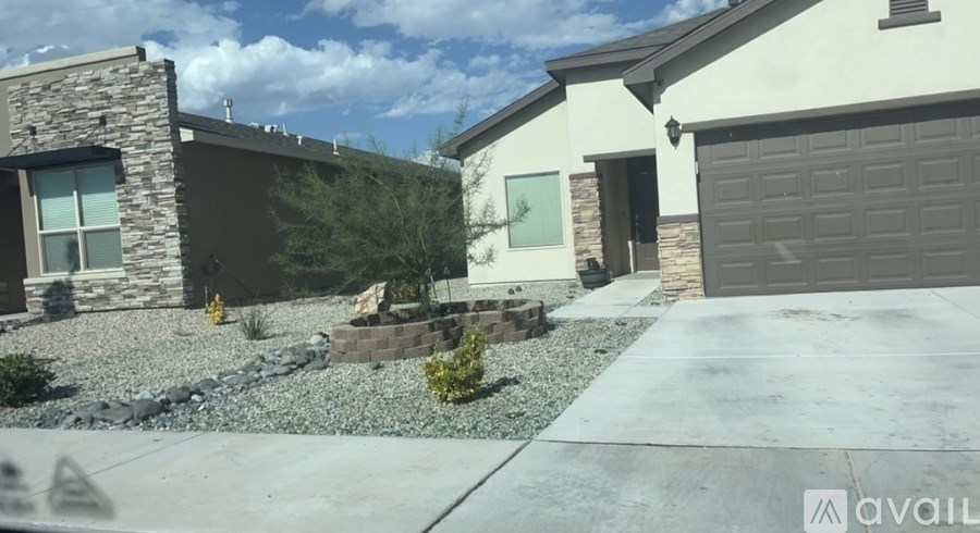 A house with a stone wall and a garage door.