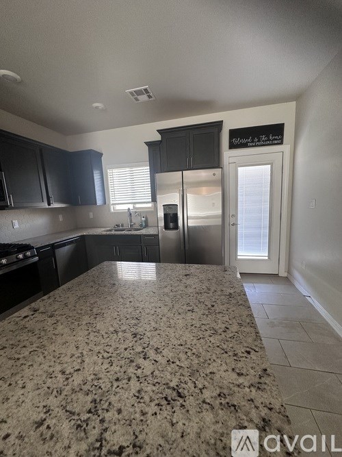 A kitchen with granite countertops and stainless steel appliances.