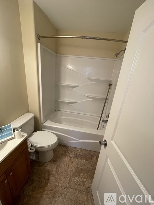 A small bathroom with a toilet, sink, and bathtub.
