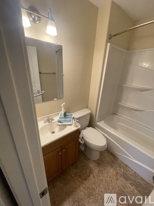 A bathroom with a toilet, sink, and bathtub.