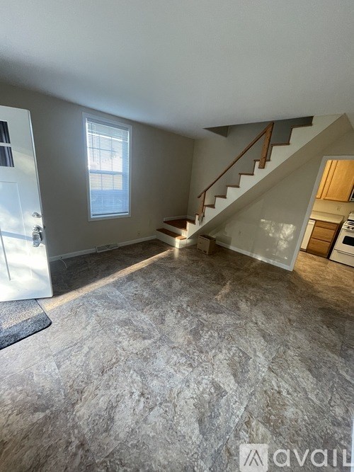 A room with a staircase and a window.