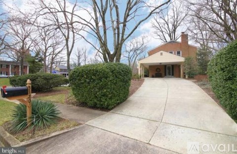A house with a driveway and a mailbox in front.