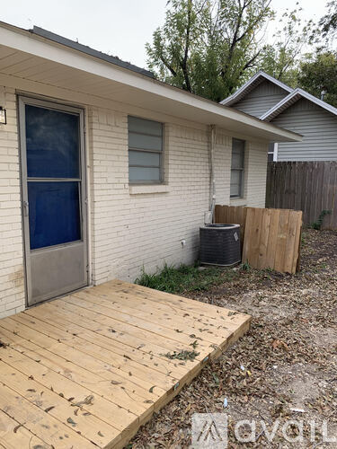 A house with a wooden deck in front.