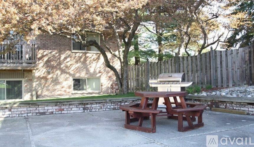 A picnic table is set up in a concrete patio.