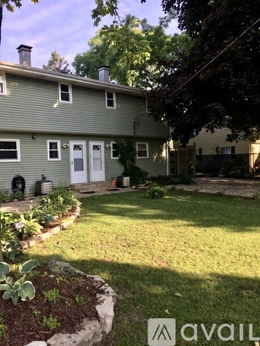 A house with a green lawn and a white door.