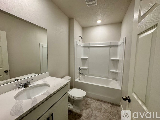 A bathroom with a toilet, sink, and bathtub.