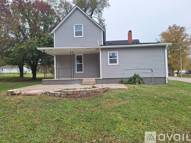 A house with a grey exterior is for sale.
