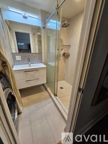 A bathroom with a washer and dryer built into the cabinetry.