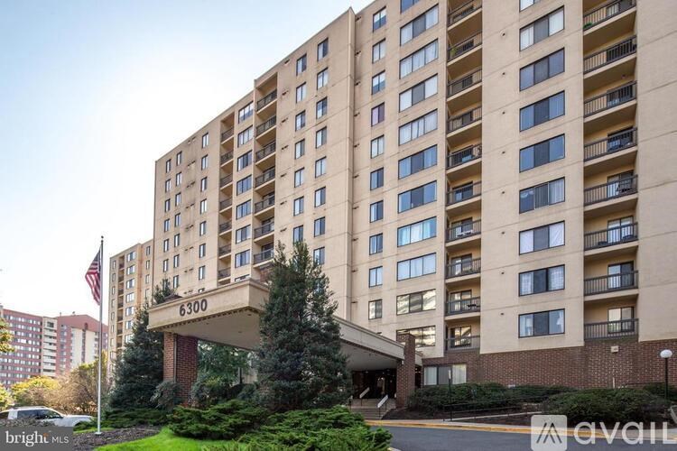 The image shows a multi-story building with the number 6300 on it.