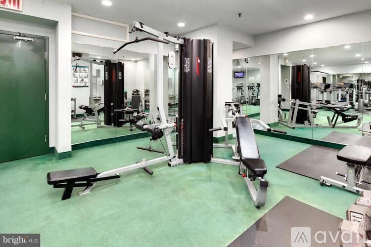 A gym with a variety of equipment including a leg press machine.