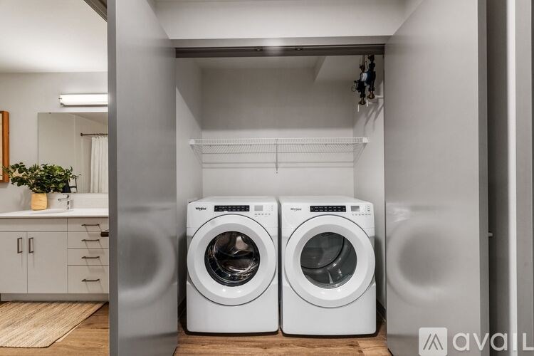 Two front load washing machines in a laundry room.