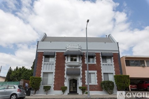 A two-story building with a red brick facade and white trim.