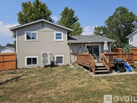 A house with a brown fence and a deck.