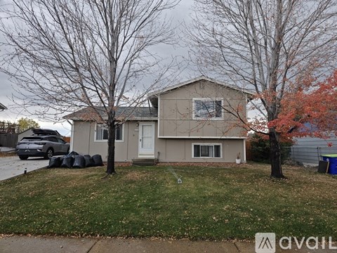A house with a car parked in front of it.